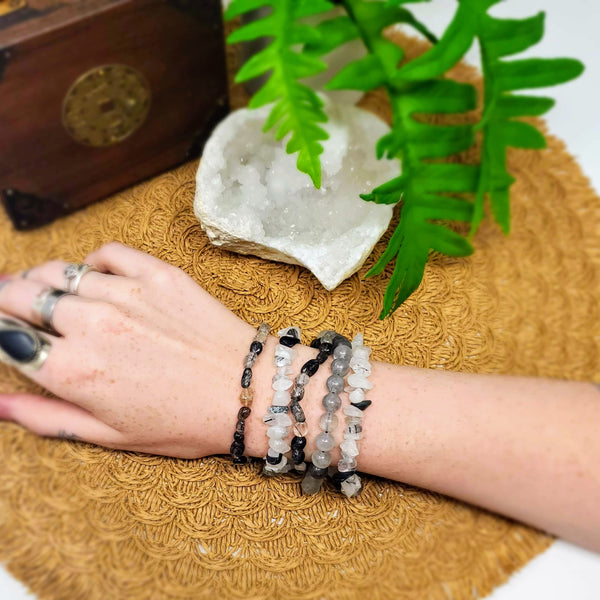 5 different styles of Black Tourmaline in Quartz bracelets adorn a wrist