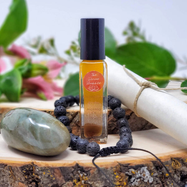 A beautiful scene featuring the contents of Feet on the Ground Morning Meditation Ritual, including Polychrome Jasper palmstone, lava diffuser bracelet, Grounding Tonic anointing oil, and guided meditation scroll, with a background of fresh flowers