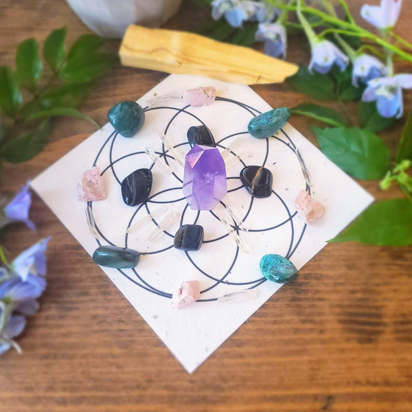 Call in Calm Crystal Grid Ritual kit includes Amethyst generator, Quartz points, palo santo, Rhodonite, Chrysocolla, Tiger's Eye and a crystal grid printed on seed paper, as shown.  This is just one example of how you can grid these beautiful stones to help you let go of your worry monsters! 