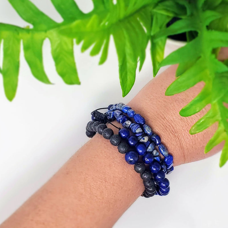 4 different styles of Lapis Lazuli bracelets on a wrist with a white background
