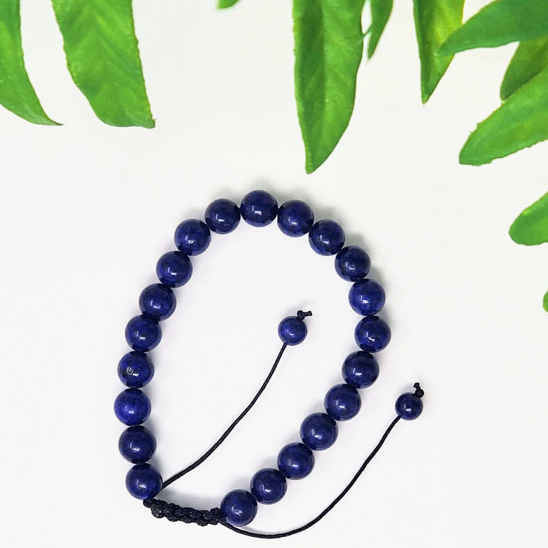 Adjustable round bead Lapis Lazuli bracelet on white background