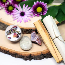 The contents of our If You Can't Love Yourself Evening Meditation Ritual Kit, including  One (1) Garnierite Palm Stone: Teaches you how to honor your magnificence.    One (1) Pink Amethyst Cluster: Reminds you that the love your seek is already within you.   One (1) 8 hour Crystal Infused Tealight Candle: To help clear your mind and increase your ability to focus.    One (1) If You Can't Love Yourself...  Meditation with Bonus Smudge Stick: To help you learn to love and accept yourself. 