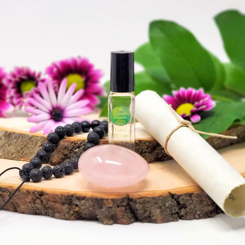 Get your Love On Morning Meditation Ritual Kit contents atop stacked natural wood slabs with fresh flowers in the background