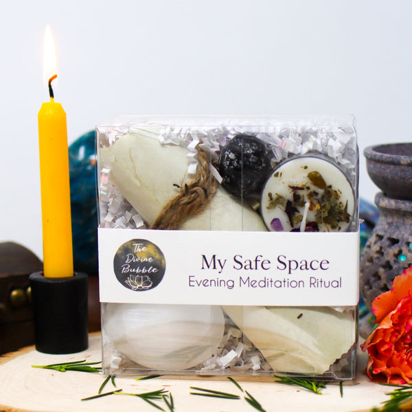 Our My Safe Space Evening Meditation Ritual kit with a burning yellow candle, Blue Apatite freeform, oil burner, and flowers around it, all on a white background