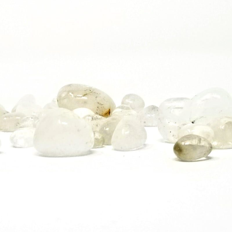 Quartz Tumbled Stones scattered about on a white background