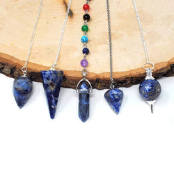Sodalite Pendulums hanging on wood slab