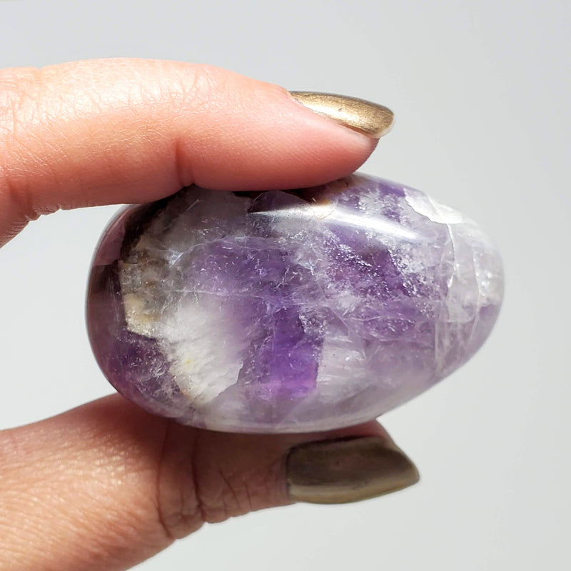A hand holding up a Chevron Amethyst 